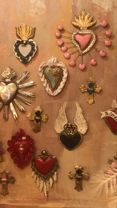 an assortment of heart and cross brooches on display