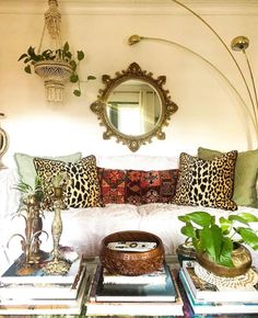 a living room filled with lots of furniture and decor on top of a wooden table