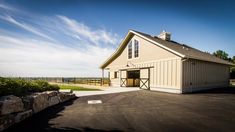 a barn with a large driveway next to it