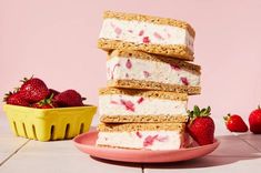 there are several pieces of cake and strawberries on the plate next to each other