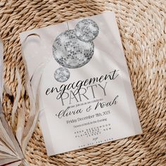 an engagement party card sitting on top of a wicker basket next to other items