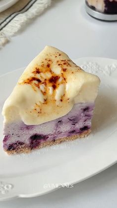 a slice of blueberry cheesecake on a white plate