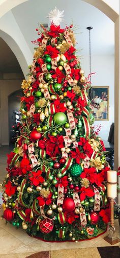 a christmas tree decorated with red, green and gold ornaments