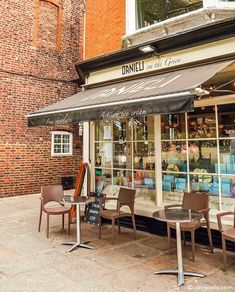 an outdoor cafe with tables and chairs outside