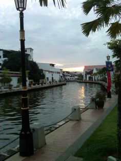 a street light sitting on the side of a river