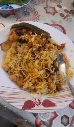 a white plate topped with rice and beans