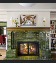 a living room with a fire place and bookshelves