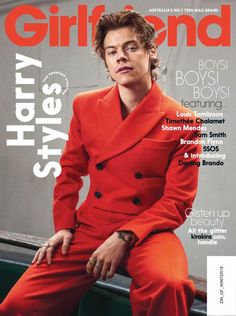 a man in an orange suit on the cover of a magazine with his hand on his hip