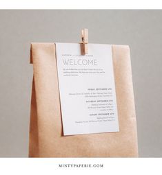 a paper bag with a welcome sign attached to it