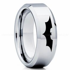 an image of a batman ring with black bats on the inside and silver inlays