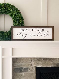 a sign that says come in and stay awhile on top of a fireplace mantel