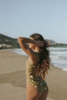 You'll always have sunshine on your mind with the Celeste One-Piece Swimsuit. This golden-olive colored modest swimsuit is detailed with a gorgeous celestial style print thats fun and flirty. Our higher leg cut flatters your curves and prevents this one piece swimsuit from digging in. The open back combined with a golden clasp and functioning tying straps is a combination we just cant resist! Made from a smooth, high quality swimsuit material, this swimsuit is soft and comfortable for whatever y Fitted Olive Swimwear For Summer, Green One-piece Swimwear With Tie Back, Celestial Style, Swimsuit Material, Modest Swimsuits, Moon Print, Olive Color, High Leg, One Piece Swimsuit