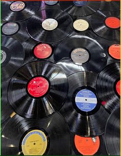 many different colored records are on display together