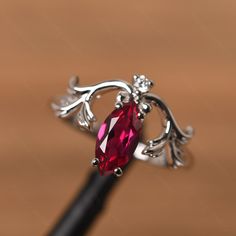 It is a ruby ring. The main stone is 5 mm* 10 mm marquise cut. weight about 1.34 carats. The basic metal is sterling silver and plated with rhodium. To change the metal to a solid gold (white/rose) or platinum is also available, please ask for a quotation if you want. You can also go to my shop Home for more elegant rings: https://www.etsy.com/shop/godjewelry?ref=hdr_shop_menu Alexandrite is June birthstone More alexandrite rings: https://www.etsy.com/shop/godjewelry?ref=seller-platform-mcnav&se Marquise Ruby Ring In White Gold, Marquise White Gold Ruby Ring, Marquise Ruby Birthstone Ring, White Gold Marquise Ruby Ring, Elegant Marquise Ruby Birthstone Ring, Elegant Silver Ruby Ring With Marquise Cut, Sterling Silver Marquise Birthstone Jewelry, Fine Jewelry Ruby Marquise Cut, Marquise Ruby Ring For Promise, Fine Jewelry