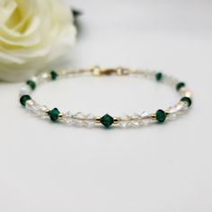 Looking for a special gift for someone with a May birthday? Consider this dainty birthstone bracelet featuring emerald green and Aurora Borealis shimmering clear crystals that sparkle brilliantly. May-born individuals are associated with the fabulous Emerald birthstone, and this delicate and sparkly bracelet is a lovely representation of that. It makes a special gift for anyone born in May under the Taurus or Gemini Zodiac signs. The bracelet has 4mm emerald green bicone-shaped premium crystals, May Birthstone Bracelets With Faceted Beads As Gift, Faceted Beads Bracelet For May Birthstone Gift, Faceted Beads Bracelets As May Birthstone Gift, May Birthstone Spacer Beads Jewelry Gift, Gift Jewelry With Spacer Beads For May Birthstone, Gift Crystal Bracelet With Spacer Beads, Spiritual Faceted Beads Crystal Bracelet Gift, Spiritual Faceted Crystal Bracelet As A Gift, May Birthstone Jewelry With Faceted Beads As A Gift