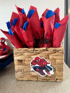 a basket filled with red and blue paper flowers