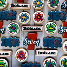 several decorated cookies are arranged on a white board with red, blue and green lettering