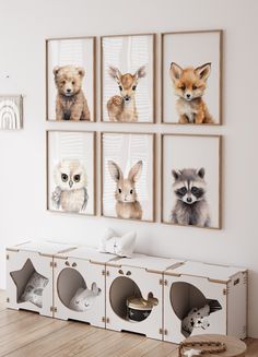 a room with four animal pictures on the wall