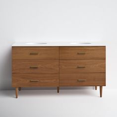 a wooden dresser with two white sinks on it's top and one drawer below