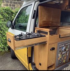 the back end of a yellow van with an oven on it