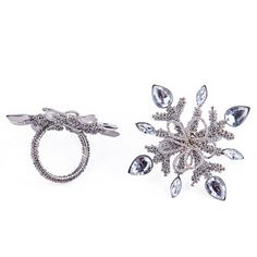 two silver rings with crystal snowflakes on them, one in the shape of a star