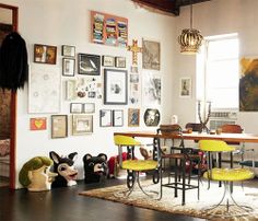 a living room filled with furniture and pictures on the wall