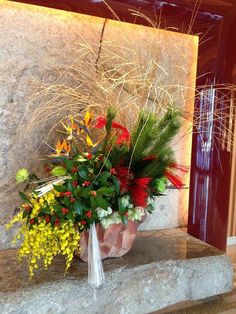 a vase filled with flowers sitting on top of a stone step