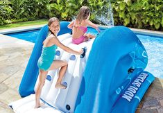 two girls playing in an inflatable pool