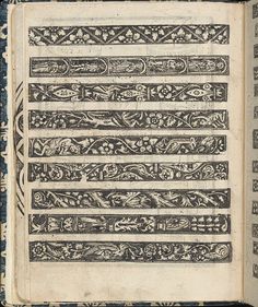 an old book with decorative designs on it's cover and pages lined up in rows