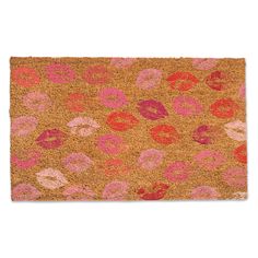 a door mat that has pink and red flowers on the front, with lips painted on it