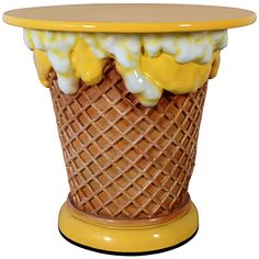 an ice cream cone with yellow and white toppings