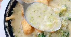 broccoli and cheese casserole is being spooned with a ladle