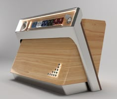 an electronic device with buttons and numbers on the front, sitting on top of a wooden stand