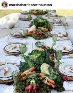 a long table is set with vegetables and place settings for an outdoor dinner or brunch