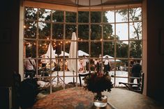 a table and chairs in front of a large window