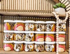 several jars filled with food sitting on top of a shelf next to a flower pot