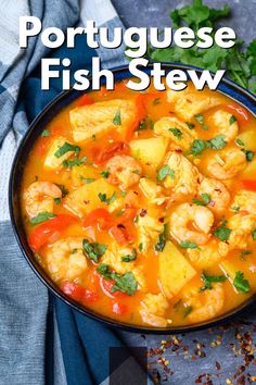 a bowl filled with shrimp and potatoes next to cilantro on top of a table