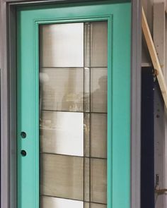 a green door with glass on the outside