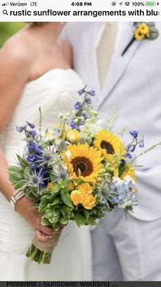 the bride and groom are posing together for a photo with sunflowers in their bouquet