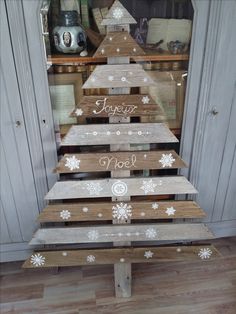 a wooden christmas tree with snowflakes on it