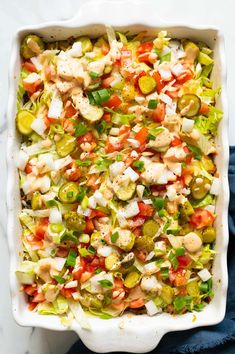 a casserole dish filled with vegetables and chicken