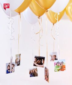 some balloons and pictures hanging from strings