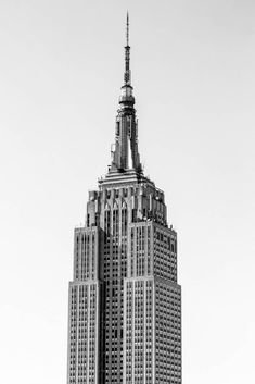 black and white photograph of the empire building in new york city, ny on a clear day