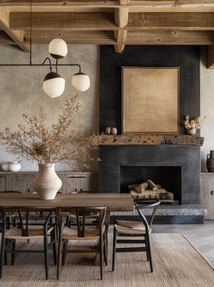 a dining room table and chairs in front of a fire place