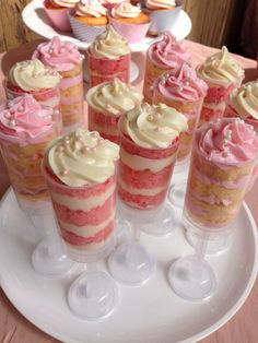 cupcakes with pink and white frosting on a plate