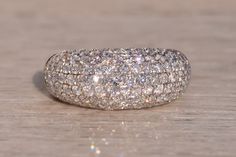 a diamond ring sitting on top of a wooden table