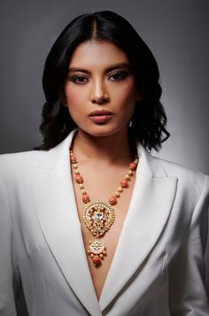 Discover elegance and sophistication with our Coral Stones & Pearls Harmony Necklace. This meticulously crafted piece is designed to elevate your style, offering a timeless beauty that complements any ensemble with grace and charm. Finish: Gold Finish Material: Brass, Corals, Pearls Color: Gold, White, Orange, Coral Size: One Size Closure Type: Box Lock Box Contains: 1 Necklace Elegant Beaded Necklaces With Pearl Pendant For Festive Occasions, Elegant Kundan Necklace With Detachable Pendant For Festive Occasions, Elegant Pendant Bridal Necklace For Festive Occasions, Elegant Long Necklace For Festive Season, Elegant Festive Beaded Necklaces, Elegant Long Temple Necklace For Celebration, Festive Fusion Style Elegant Necklaces, Festive Fusion Style Elegant Necklace, Elegant Beaded Necklace With Pearl Pendant For Celebration