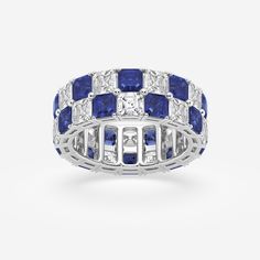 a white gold ring with blue sapphires and diamonds on the sides, set in 18k white gold