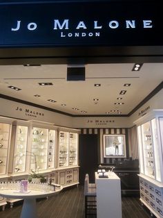 the inside of a jewelry store with lots of counter space and lights on it's ceiling