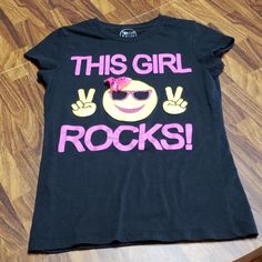 This Girl Rocks Black Tshirt With A Little Pink Accent Bow On The Smiley Face. Basically Brand New. Cute Black T-shirt With Text Print, Fun Black Tops With Text Print, Fun Black Top With Text Print, Fun Black Slogan Top, Fun Black Slogan T-shirt, Graffiti Tshirt, Girls Black, Pink Accents, Girls Rock